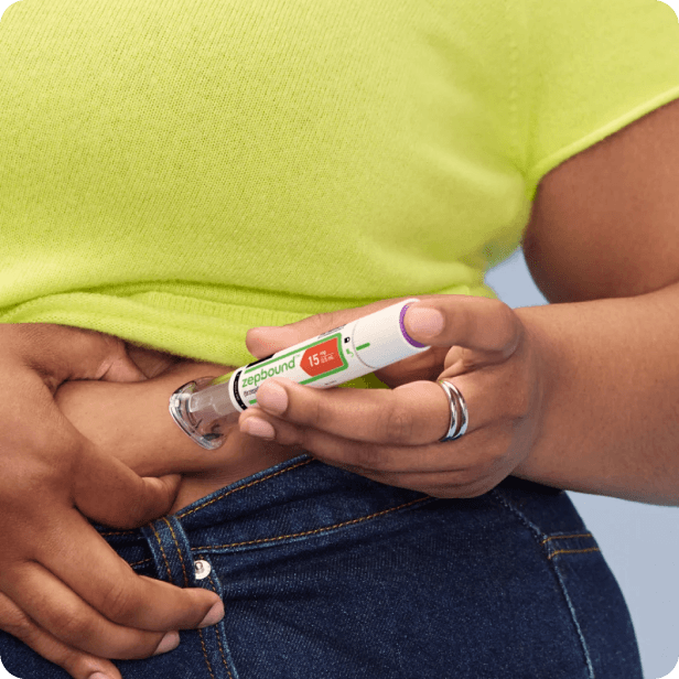 Woman holding the Mounjaro injection at her waist