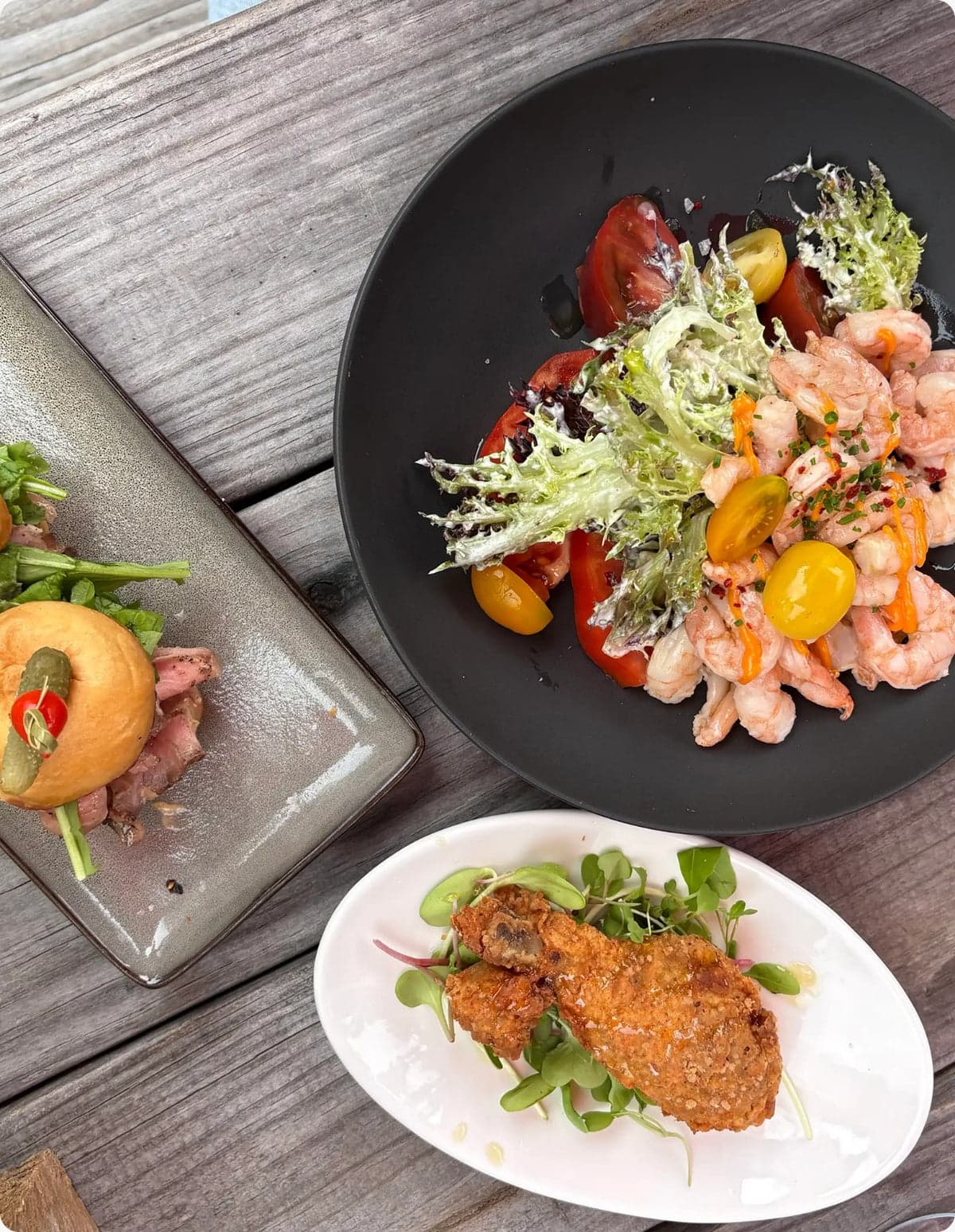 Plated restaurant dishes on a wooden table