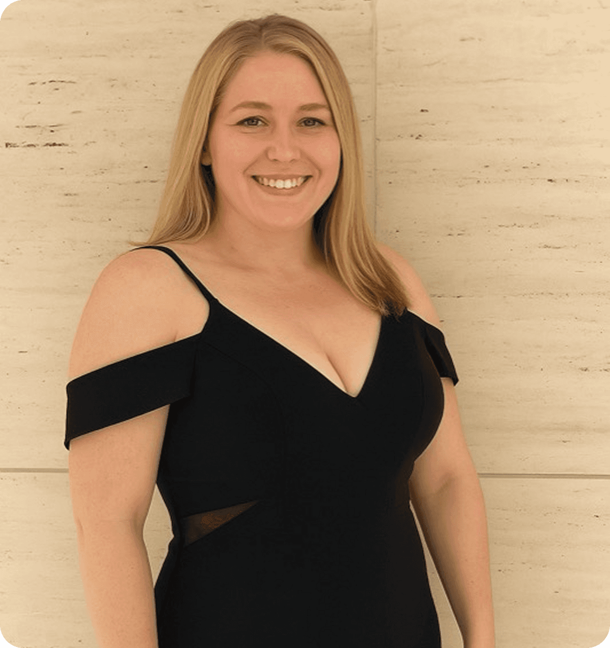 A smiling woman standing confidently