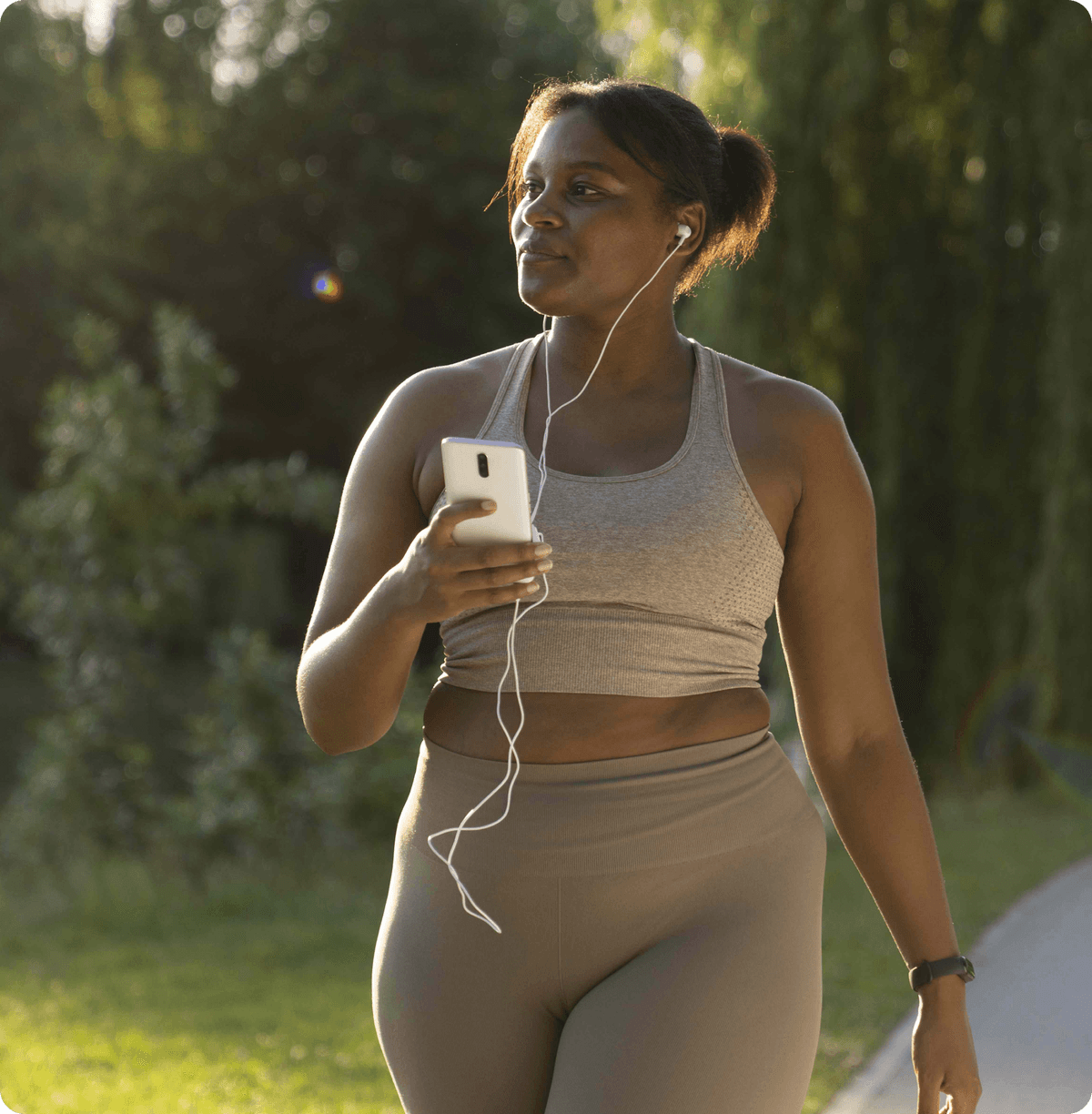 A woman walking outdoors in activewear